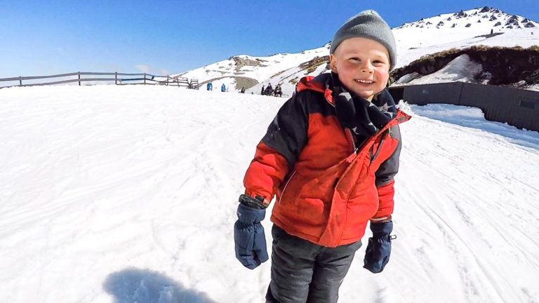 Nathan from Backyard Travel Family smiles after he completes his first run on the beginners slop at Mt Hutt Skifield, Canterbury, New Zealand