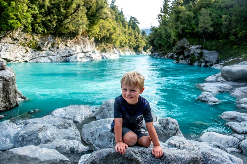 Kipton from Backyard Travel Family explores the rocks on the Hokitika Gorge Walk, West Coast, New Zealand