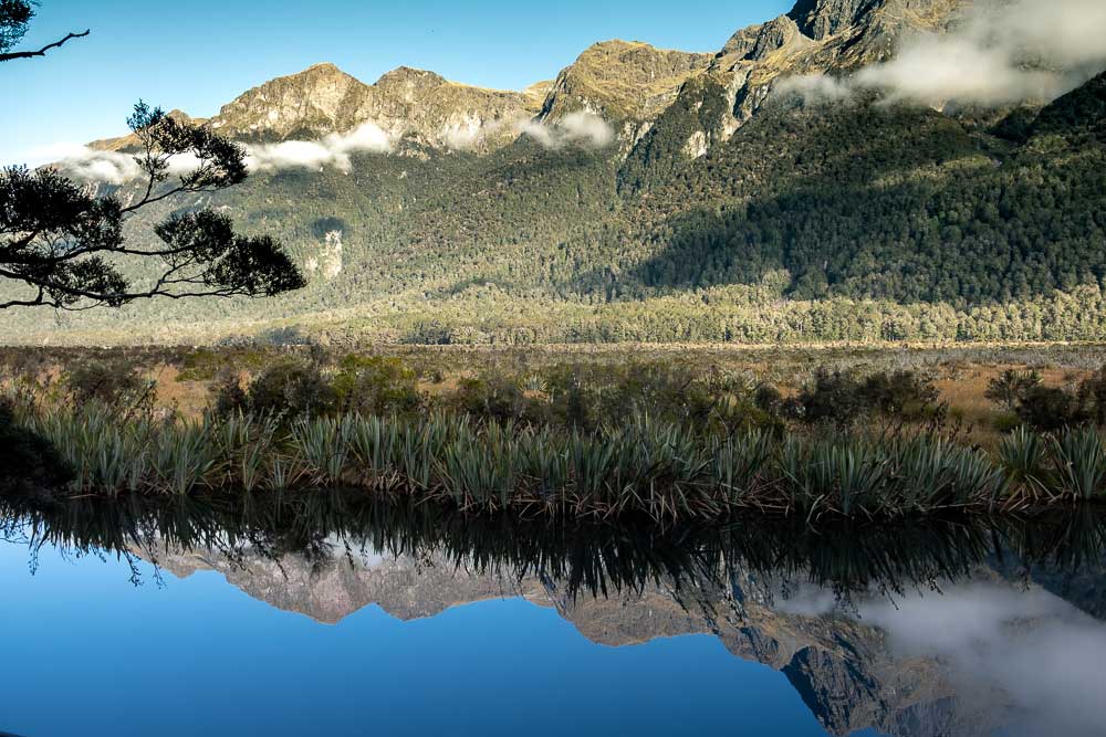 Beautiful reflections at Mirror Lakes, Fiordland, on the Milford Sound Road, by Backyard Travel Family