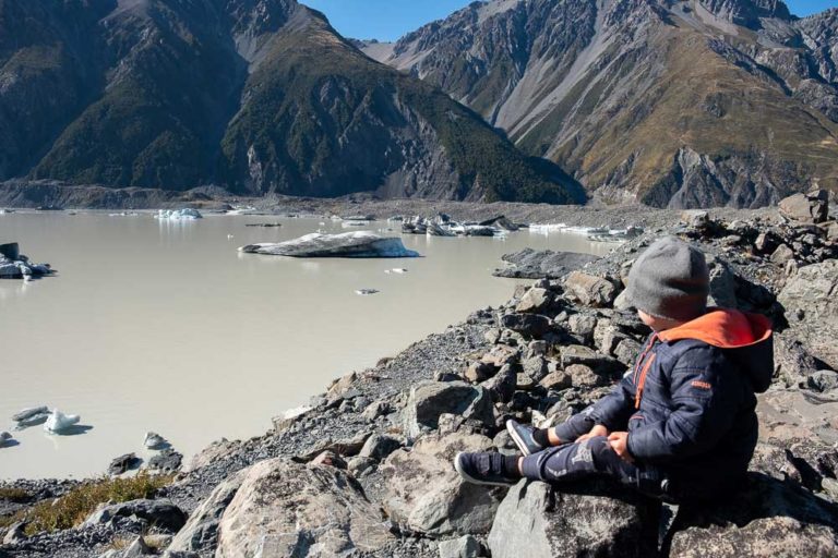 Kipton from Backyard Travel Family check out the icebergs at the Tasman Lake, on the Tasman Glacier Lake Walk, Short walk in Mt Cook National Park, perfect family walk with kids