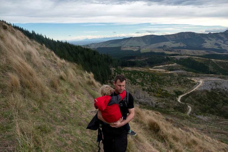 5 minutes from Packhorse Hut, Ashley from Backyard Travel Family carries 3 year old Kipton on the narrow ridgeline track // Packhorse Hut Track, Canterbury, New Zealand