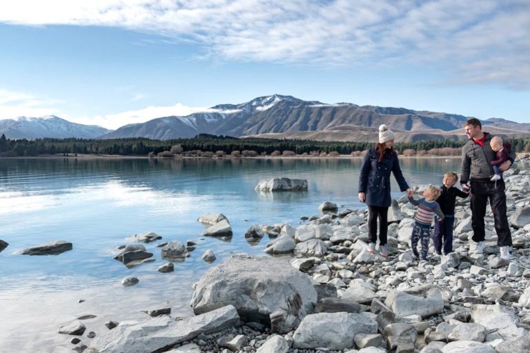Backyard Travel Family walking hand in hand, checking out the many things to do in Lake Tekapo with kids in winter // Mackenzie Region, Canterbury, New Zealand