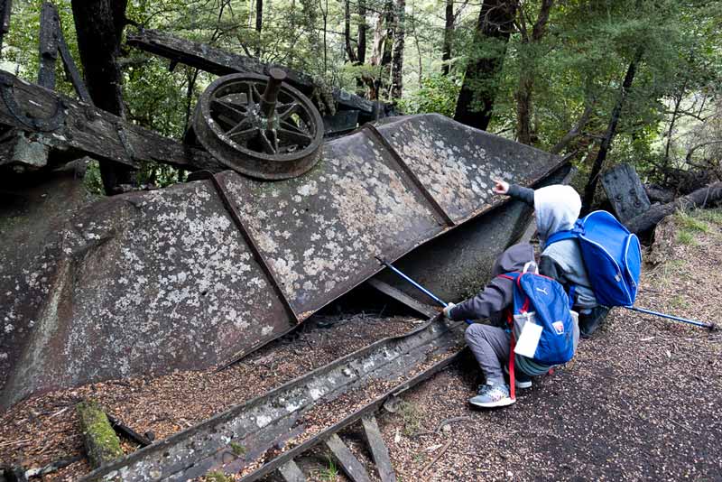 Nathan from Backyard Travel Family examines the old coal mining ruins on the Woolshed Creek Hut Walk, Mt Somers Track / A great half day walk for the family or beginners overnight hike
