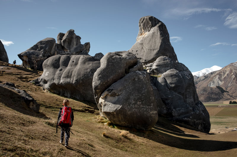 Nathan from Backyard Travel Family walks through the amazing rock formations at Castle Hill, Arthurs Pass, New Zealand