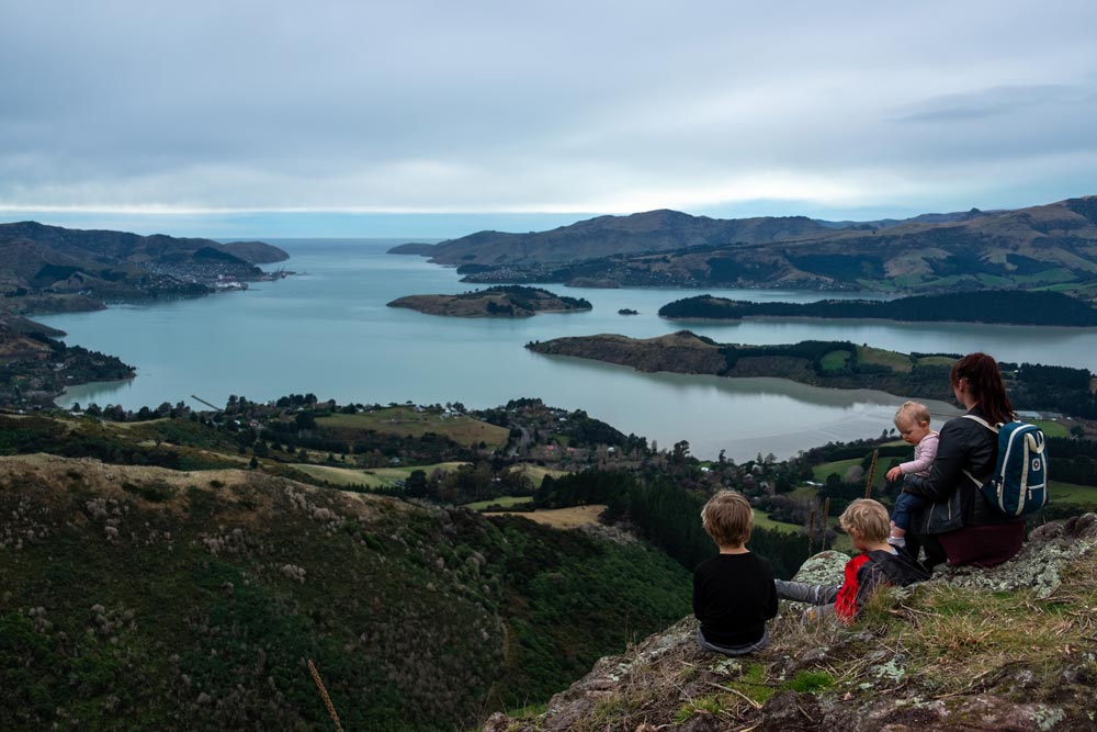 Backyard Travel Family overlook the Lyttelton Harbour from the Sign of the Bellbird, Christchurch, New Zealand