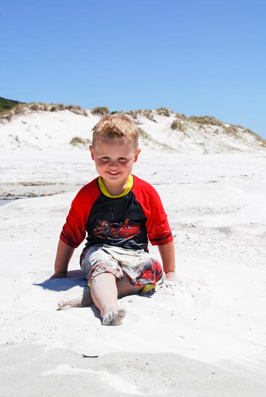 Kipton from Backyard Travel Family delights in the bright white sand at Rarawa Beach in New Zealands far north
