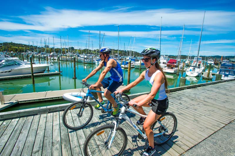 2 cyclists on the boardwalk in Opua on the Twin Coastal Cycle Trail, Northland