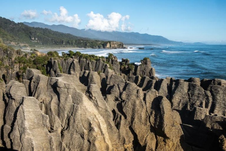 The classic view of Pancake Rocks Punakaiki with the beautiful West Coast ocean in the background