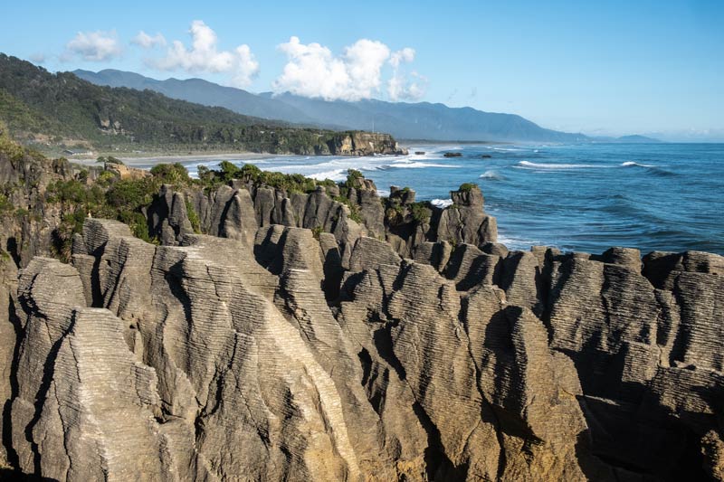 The classic view of Pancake Rocks Punakaiki with the beautiful West Coast ocean in the background