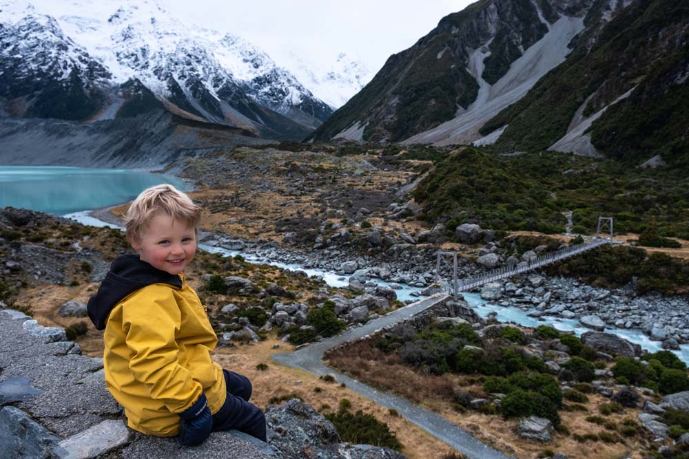 Kipton from Backyard Travel Family overlooks the first swing bridge at the start of the Hooker Valley Track