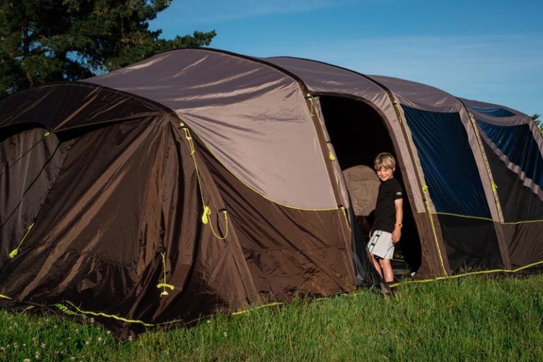 Nathan from Backyard Travel Family walks into his Zempire Aero TXL Pro tent in the camping ground, NZ