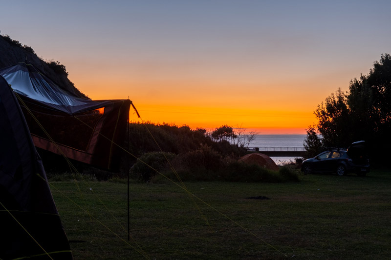 Deep orange sunset over the ocean from the Putangirua Pinnacles campisite
