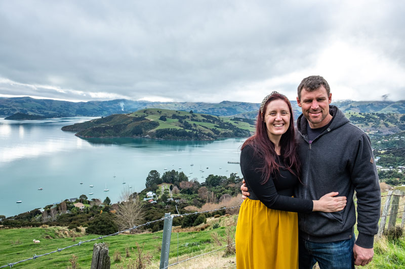 Ashley and Jen from Backyard Travel Family with the view of Akaroa Harbour in behind them