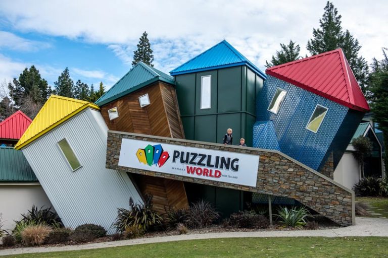 Boys stand in front on the wonky buildings at Puzzling World Wanaka New Zealand