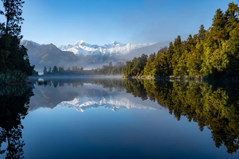 Sunrise at Lake Matheson with a beautiful reflection of Mt Cook and Mt Tasman
