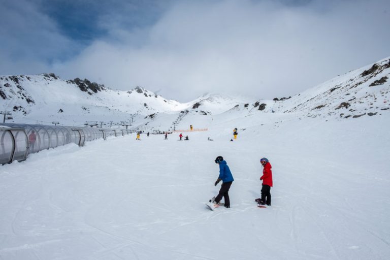 Wide angle of beginners ski area and magic carpet tube in Queenstown New Zealand ski area