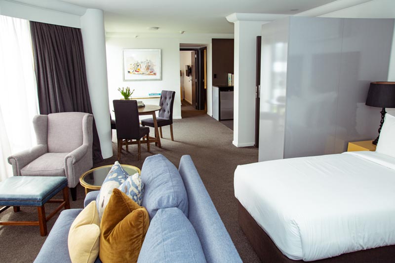Hotel Montreal offers luxury family accommodation in Christchurch with roomy sitting area at the end of the bed and kitchen space and separted bedroom which is ideal for families