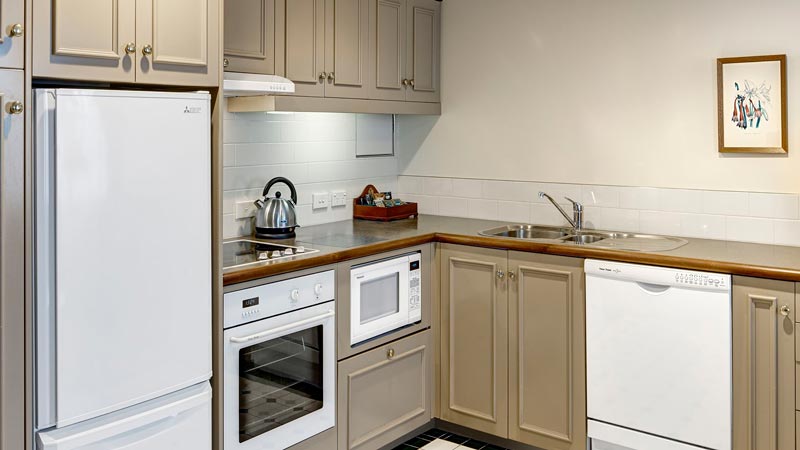 Beige kitchen with full sized dishwasher and fridge makes this great family friendly accommodation in Christchurch
